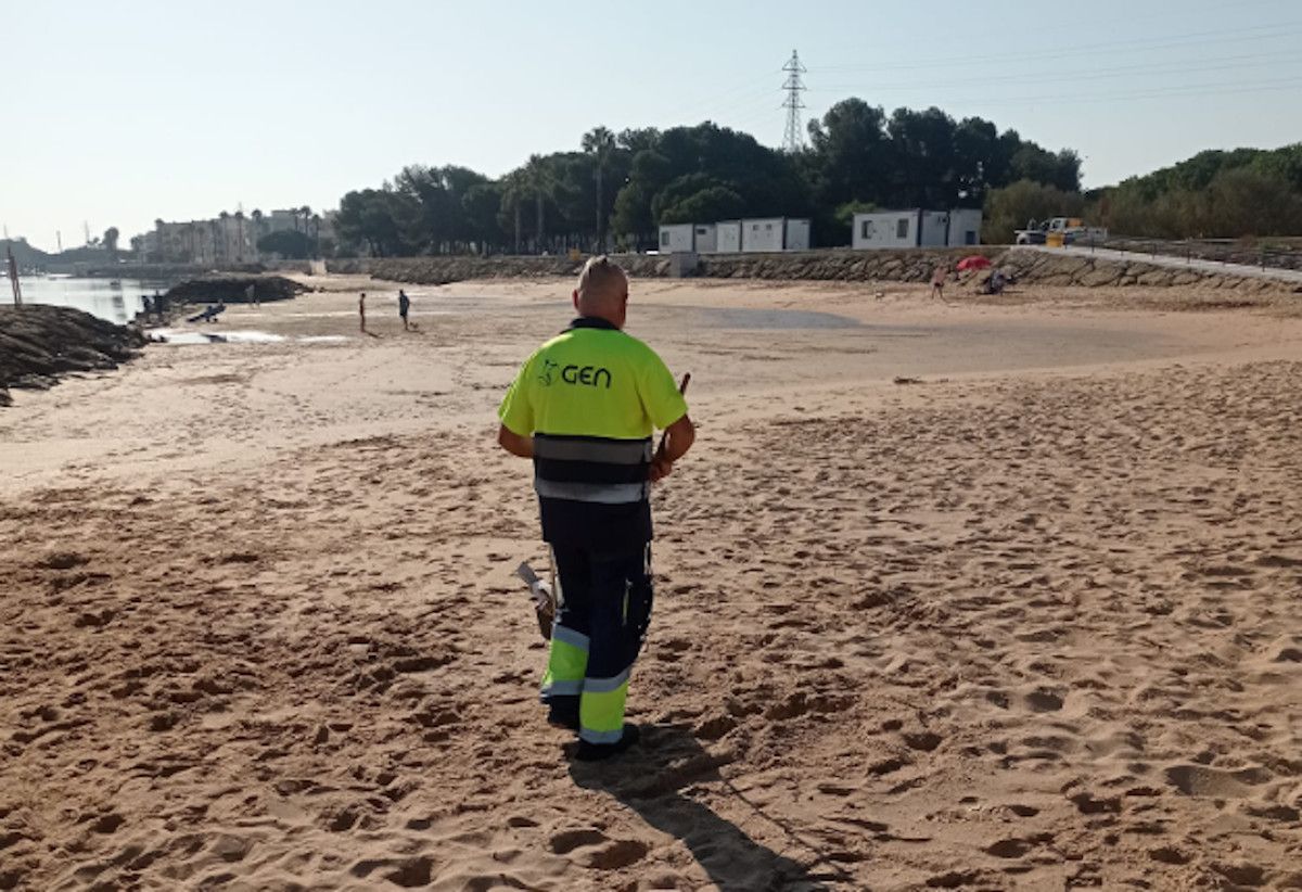 El trabajador de GEN limpiando la playa de Río San Pedro en Puerto Real.