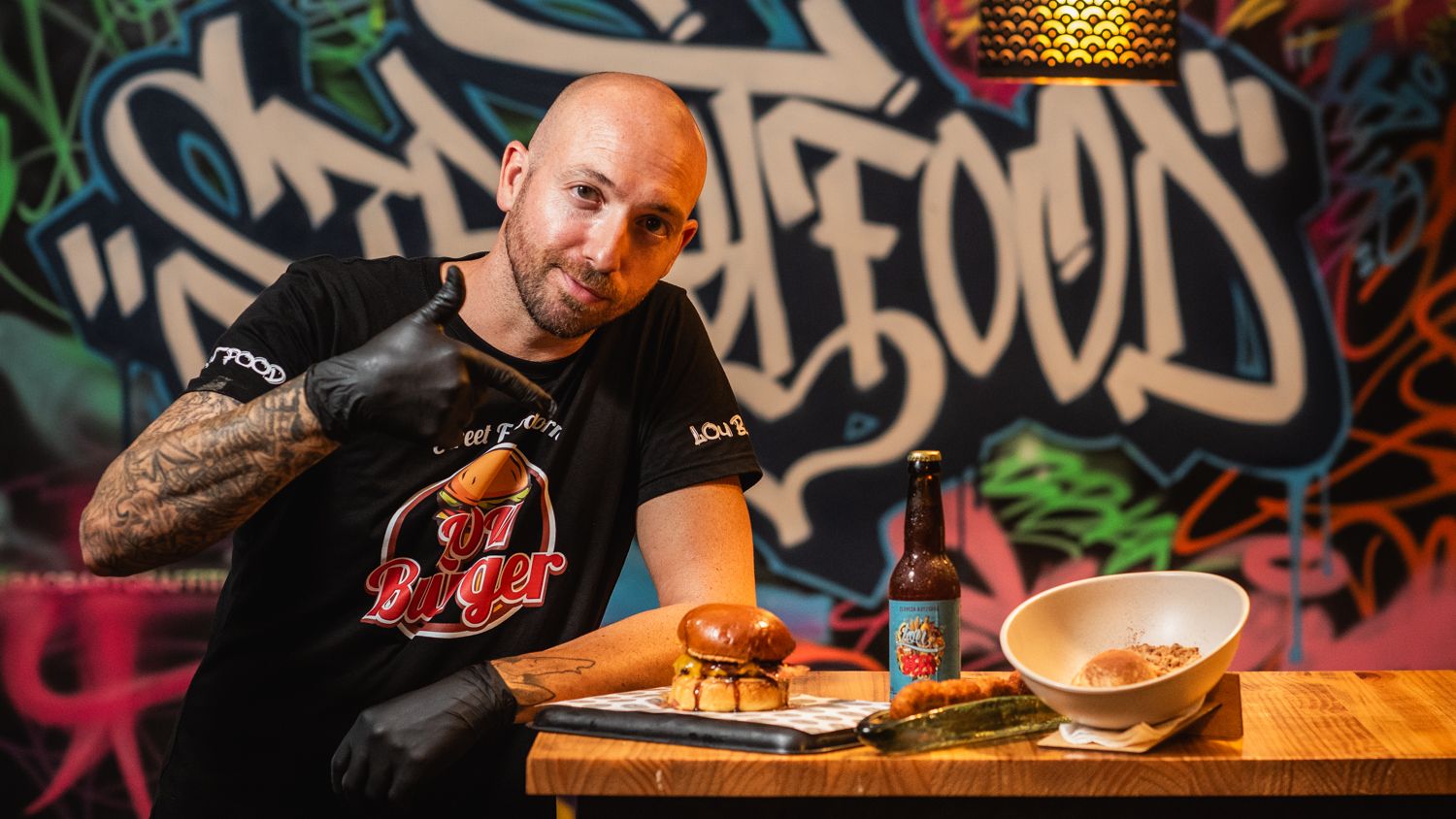 Manu Martín, junto a unos platos de Lou Burger.