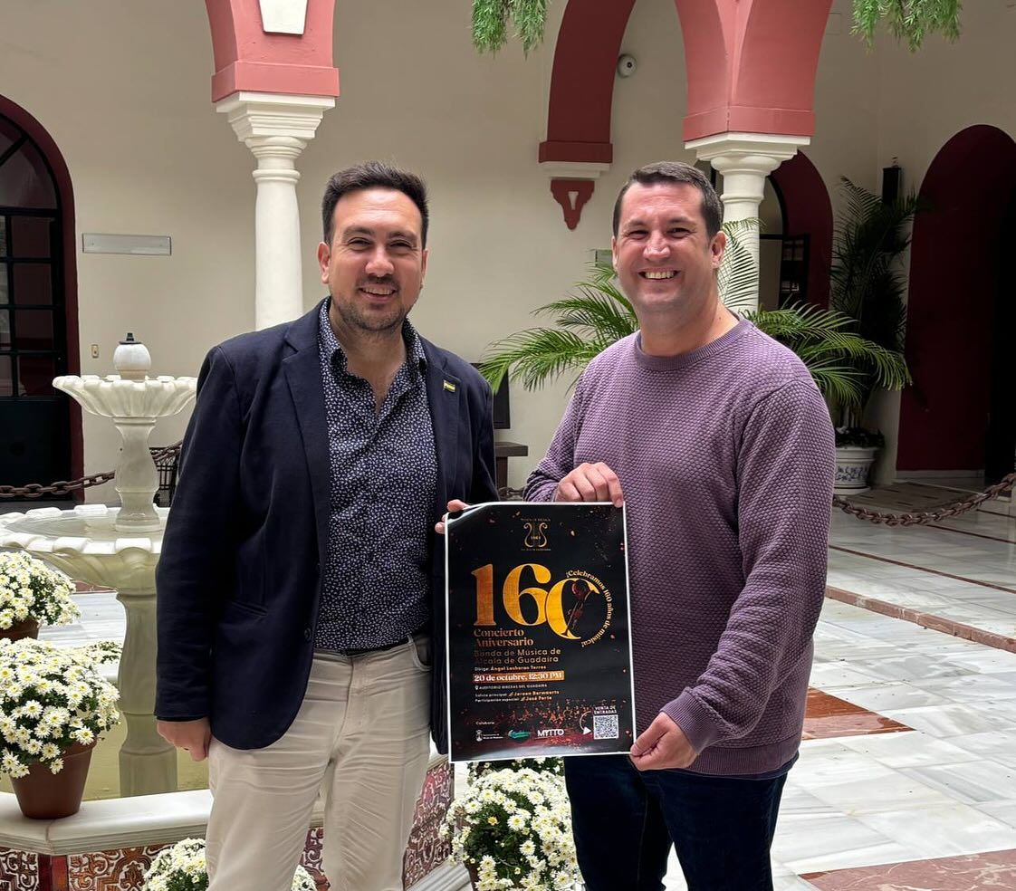 La banda de música de Alcalá de Guadaíra cumple 160 años. Rivas y Lasheras con el cartel del evento.