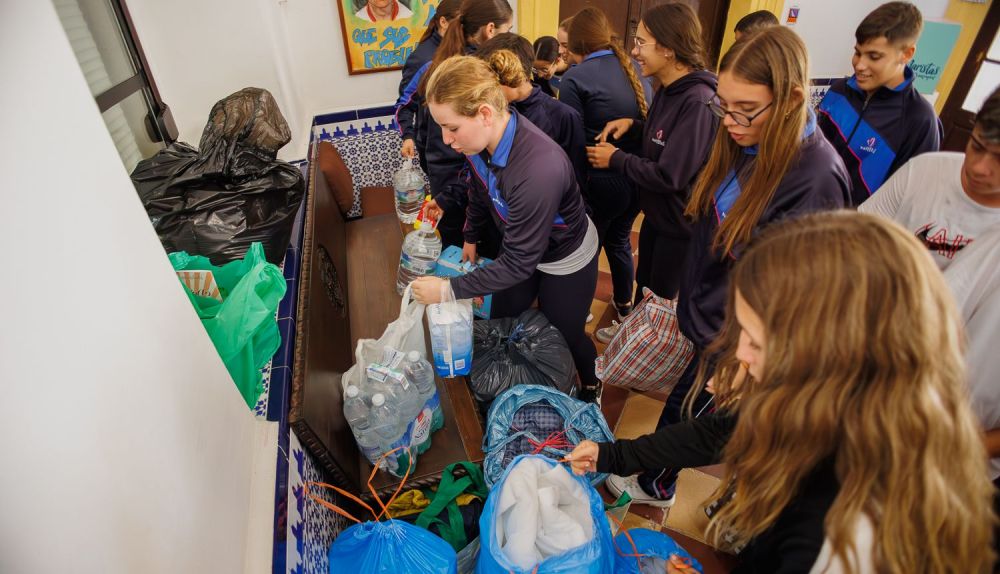 Los alumnos y alumnas del colegio Maristas cargando bolsas.