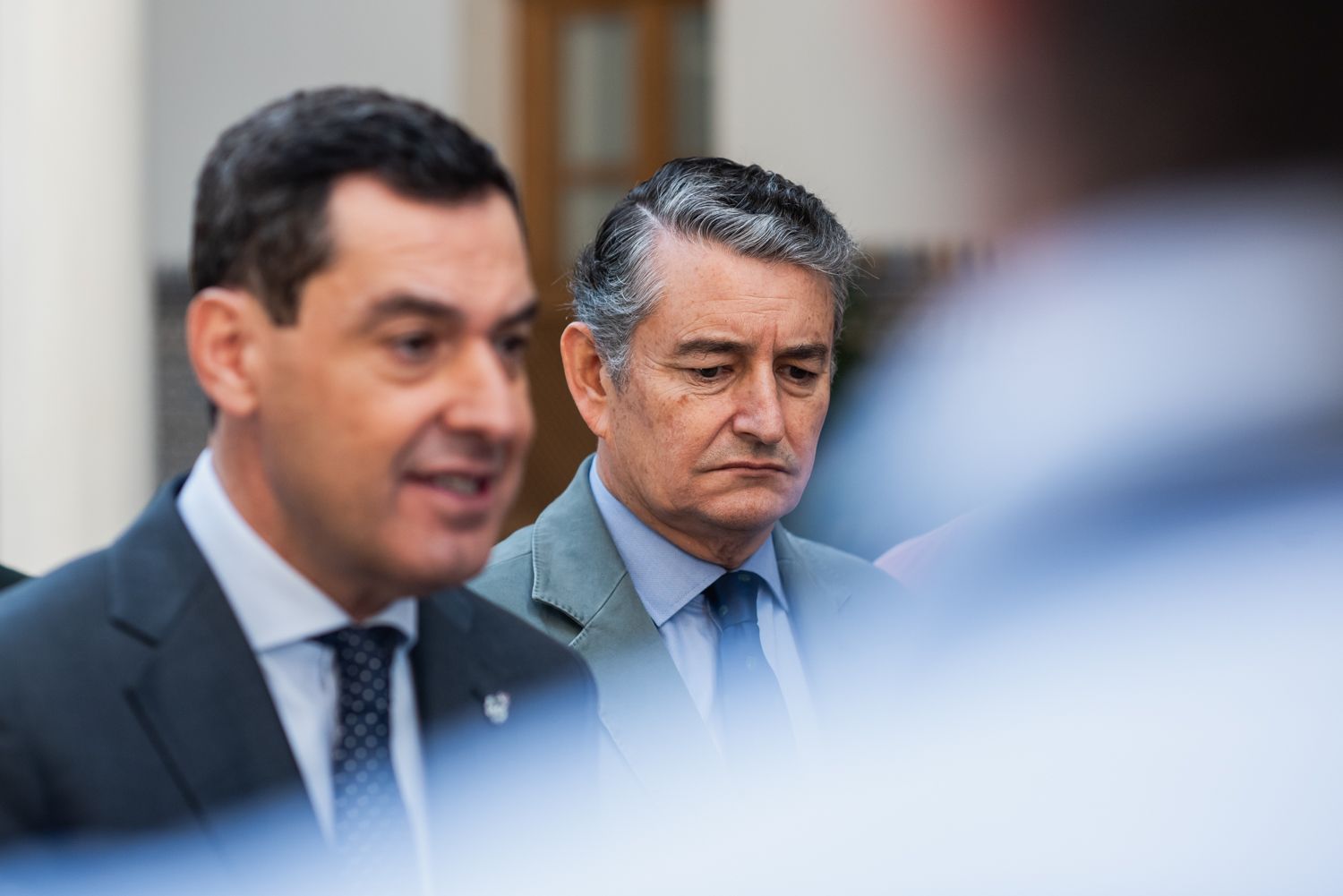 Juanma Moreno, presidente de la Junta, y Antonio Sanz, consejero de Presidencia, en una fotografía reciente del pleno del Parlamento Andaluz.