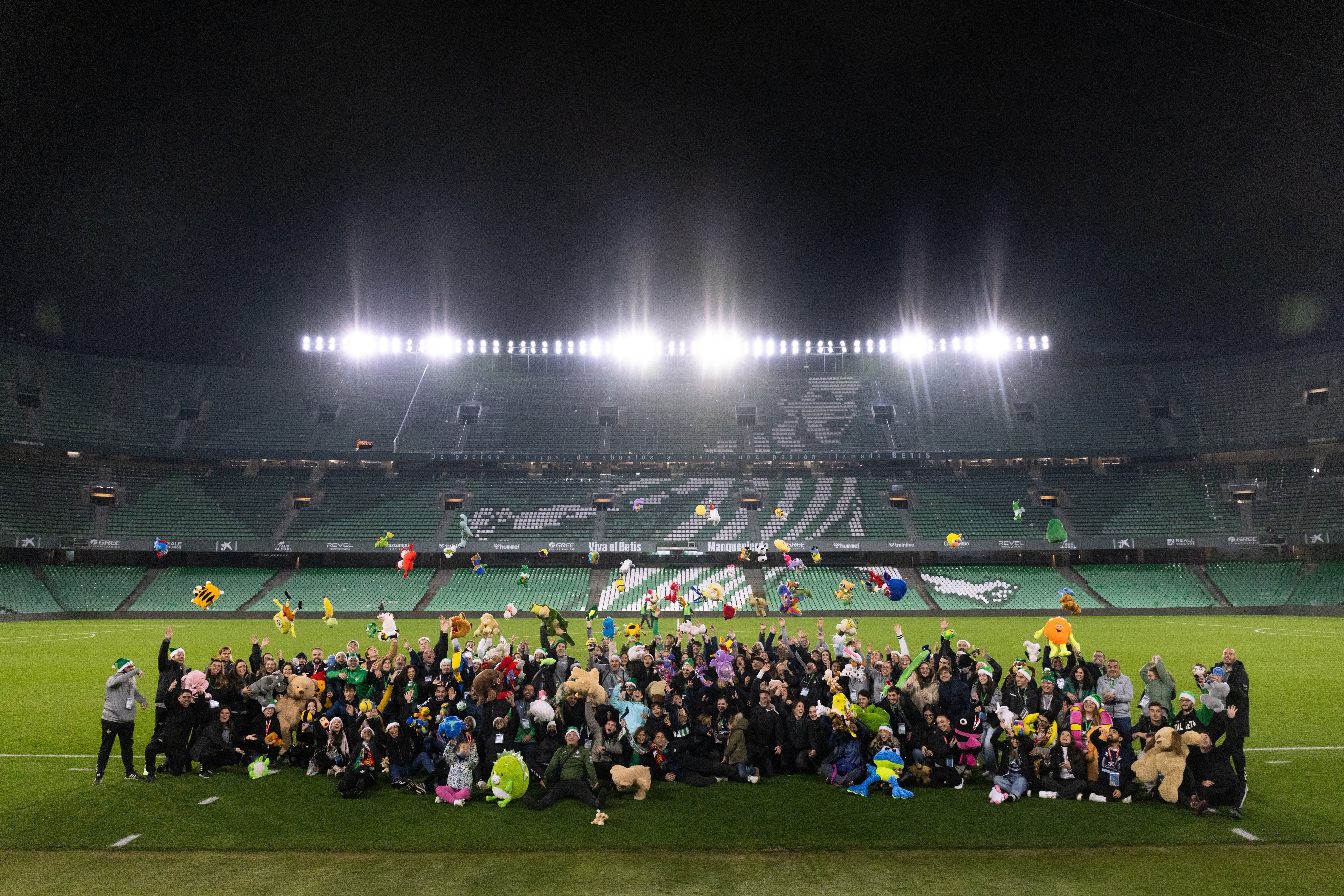 Trabajadores del Betis tras el partido con los peluches.